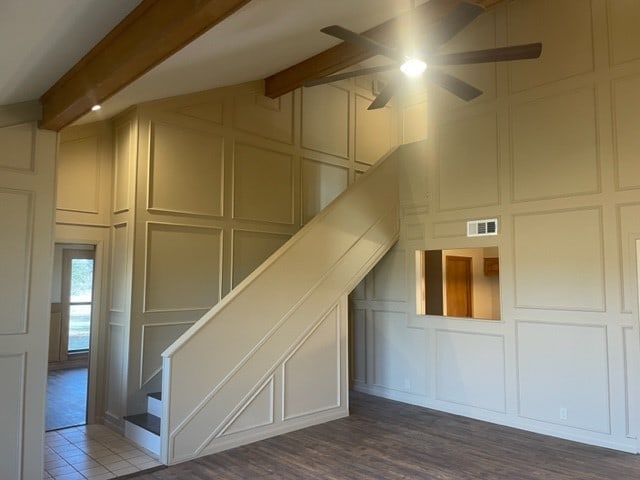 additional living space with ceiling fan, hardwood / wood-style flooring, and beamed ceiling