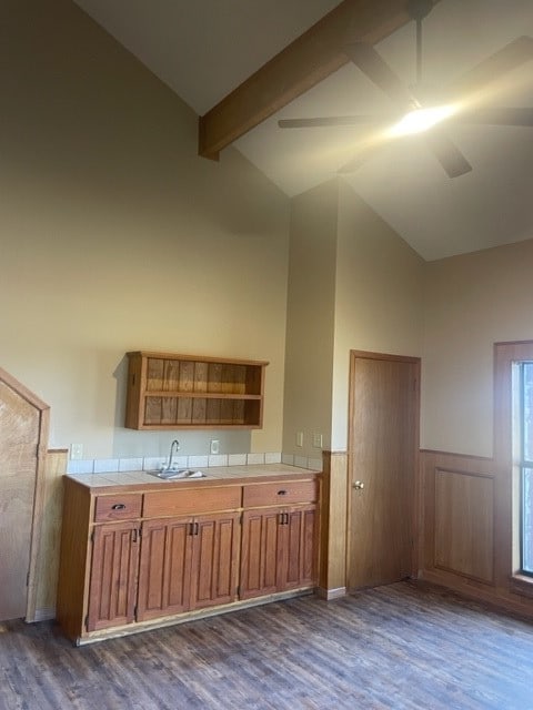 kitchen featuring vaulted ceiling with beams, dark hardwood / wood-style floors, and sink