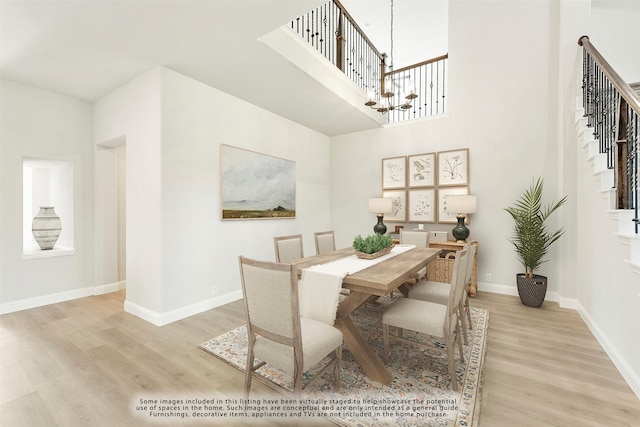 dining room featuring light wood-type flooring and a chandelier