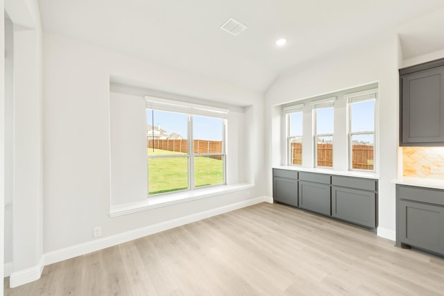 interior space with light hardwood / wood-style flooring and vaulted ceiling