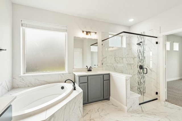 bathroom featuring vanity and shower with separate bathtub