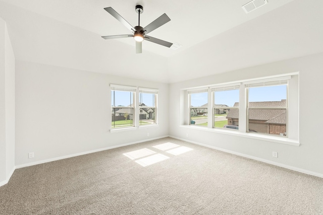 carpeted spare room with vaulted ceiling and ceiling fan