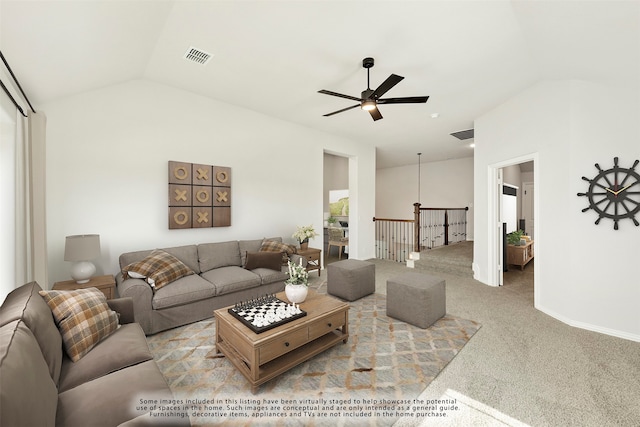 carpeted living room with ceiling fan and lofted ceiling