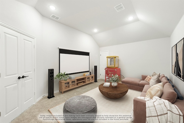 home theater featuring light colored carpet and vaulted ceiling