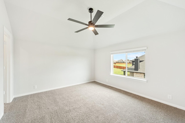 carpeted empty room with vaulted ceiling and ceiling fan