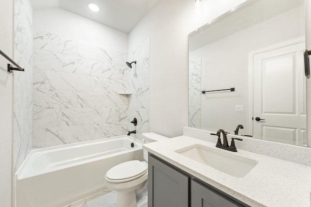 full bathroom featuring vanity, tiled shower / bath combo, and toilet