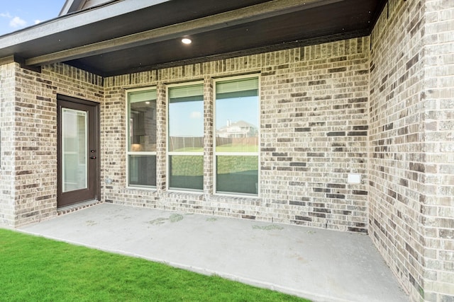 entrance to property featuring a patio area