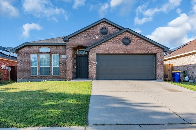 view of front facade with a front yard and a garage