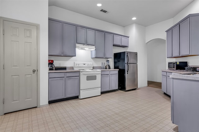 kitchen featuring appliances with stainless steel finishes, gray cabinetry, and light tile floors