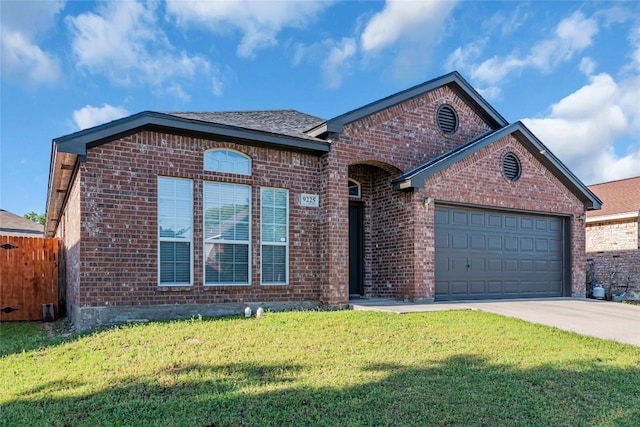 view of front of property featuring a garage and a front lawn