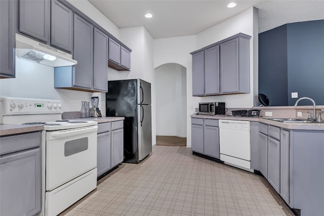 kitchen featuring light tile floors, gray cabinets, white appliances, and sink