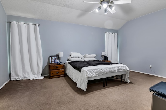 bedroom with lofted ceiling, dark carpet, ceiling fan, and a textured ceiling