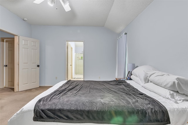 carpeted bedroom with connected bathroom, vaulted ceiling, ceiling fan, and a textured ceiling