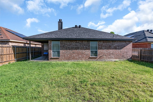 back of house with a yard