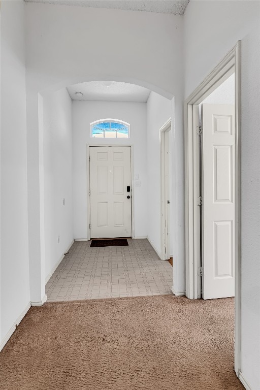 entrance foyer with light carpet