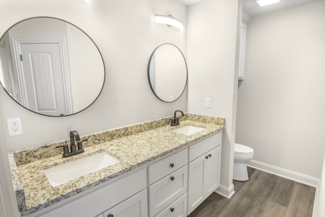 bathroom featuring vanity, toilet, and hardwood / wood-style floors