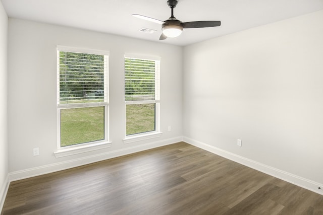 unfurnished room with dark wood-type flooring and ceiling fan