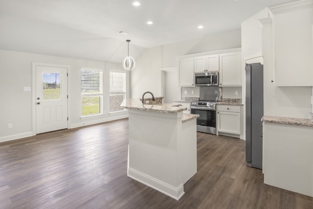 kitchen with stainless steel appliances, a kitchen island with sink, pendant lighting, and white cabinets