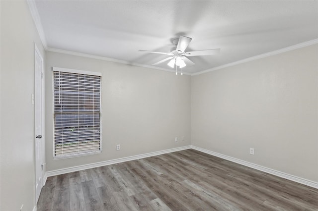 unfurnished room featuring dark hardwood / wood-style flooring, ceiling fan, and crown molding