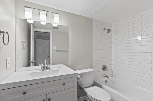 full bathroom with tiled shower / bath combo, toilet, and vanity