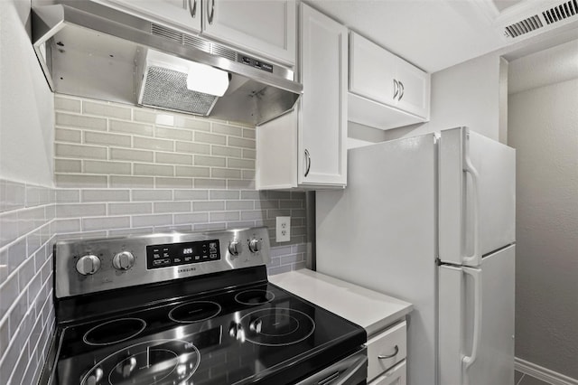 kitchen featuring stainless steel range with electric stovetop, white cabinetry, and tasteful backsplash