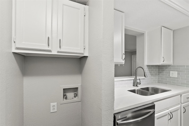 interior space featuring white cabinetry, dishwasher, tasteful backsplash, and sink