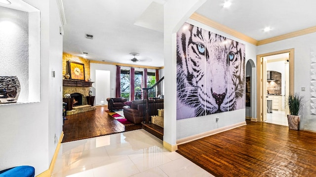 corridor featuring crown molding and light tile flooring