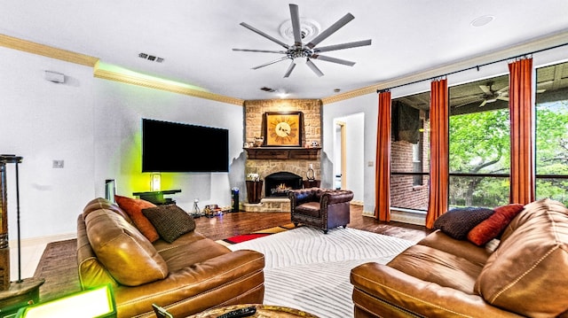 living room with crown molding, dark hardwood / wood-style flooring, ceiling fan, and a fireplace