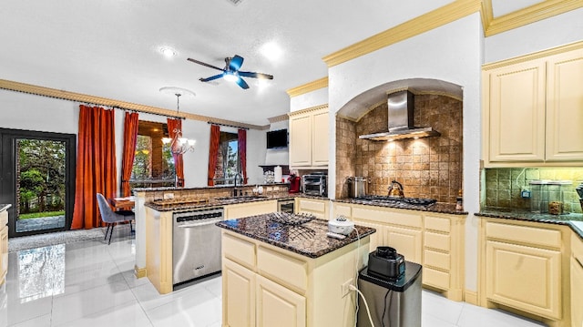 kitchen featuring light tile floors, wall chimney exhaust hood, tasteful backsplash, ceiling fan with notable chandelier, and stainless steel appliances