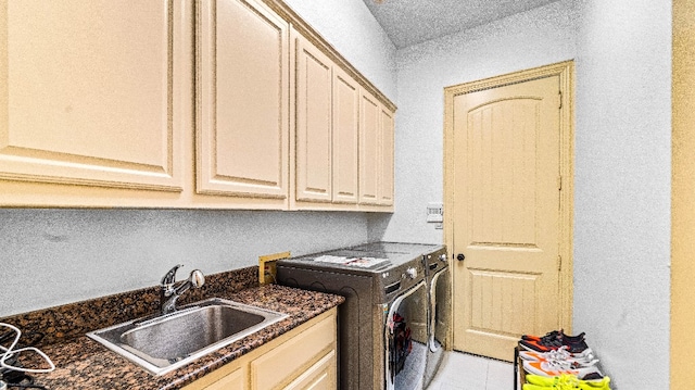 laundry room with hookup for a washing machine, cabinets, washer and clothes dryer, sink, and light tile floors