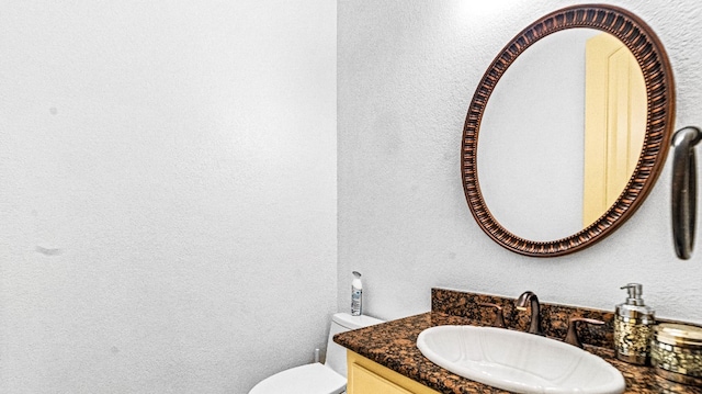 bathroom featuring large vanity and toilet