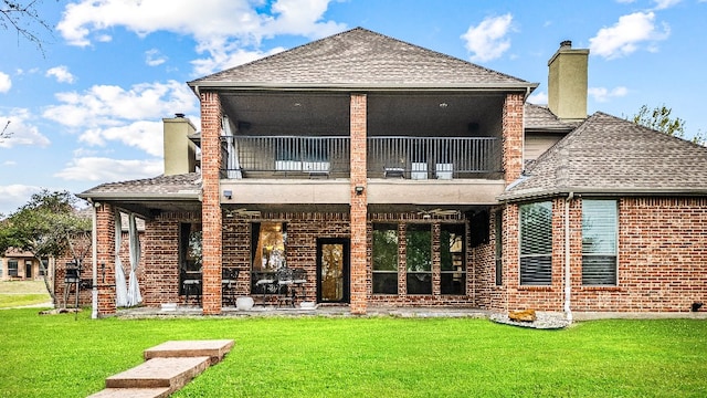 back of property with a balcony and a lawn