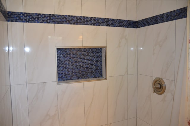 interior details with a tile shower