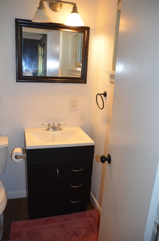 bathroom featuring toilet and vanity