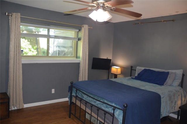 bedroom featuring dark hardwood / wood-style flooring and ceiling fan