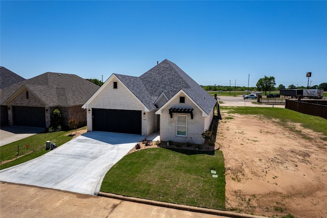 view of front of property featuring a front yard and a garage