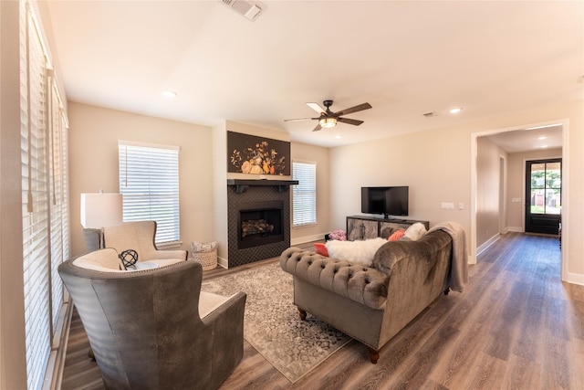 living room with dark hardwood / wood-style flooring and ceiling fan