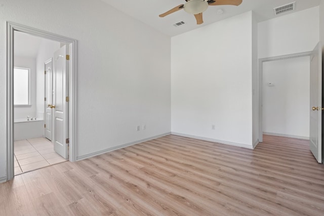 empty room with light hardwood / wood-style flooring and ceiling fan