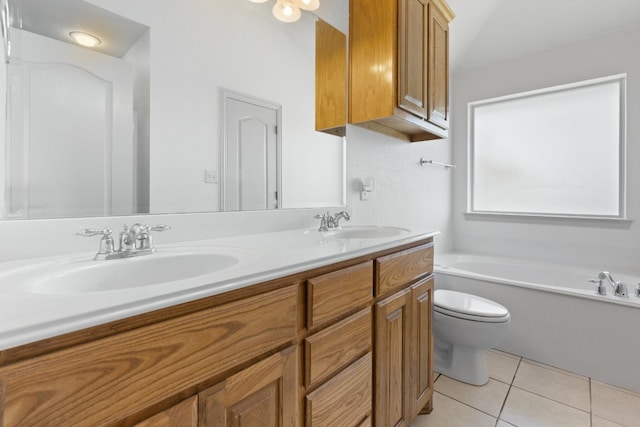 bathroom featuring tile flooring, double sink vanity, toilet, and a bath