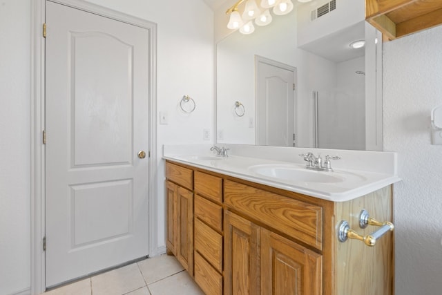 bathroom with tile flooring and double vanity