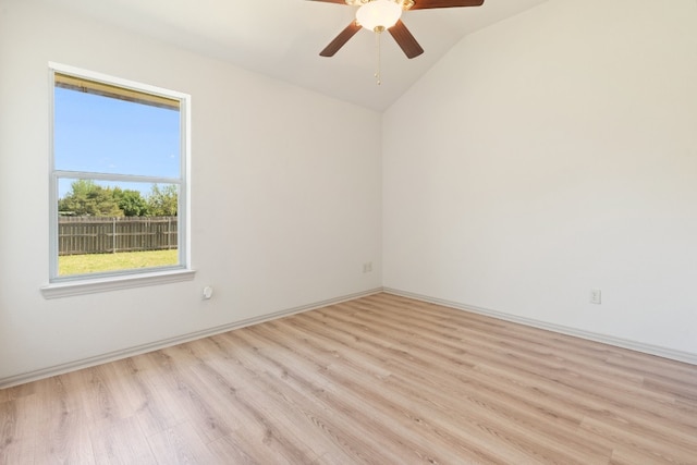 unfurnished room with ceiling fan, light hardwood / wood-style floors, and vaulted ceiling