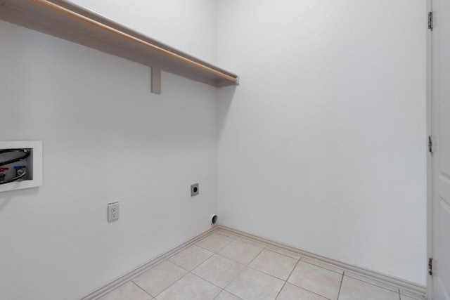 clothes washing area featuring light tile floors, electric dryer hookup, and hookup for a washing machine