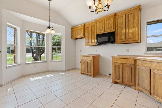 kitchen featuring light tile flooring, a notable chandelier, and a healthy amount of sunlight