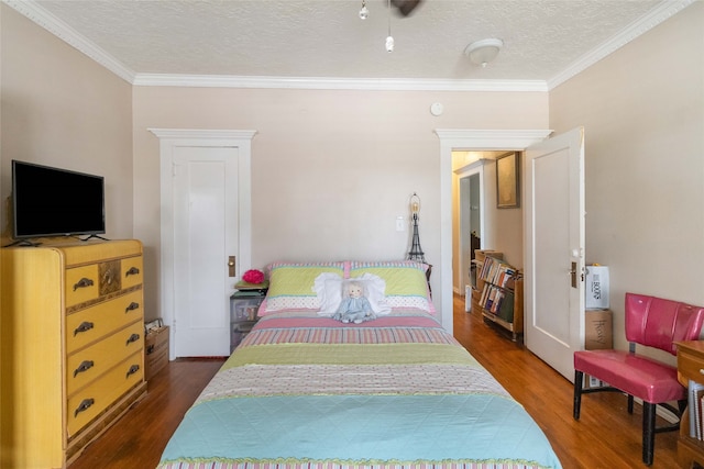 bedroom featuring ornamental molding, a textured ceiling, and dark wood-type flooring