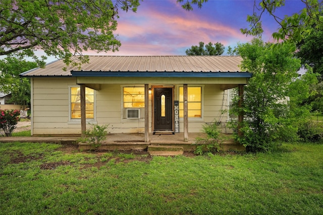 view of front of home featuring a lawn and a porch