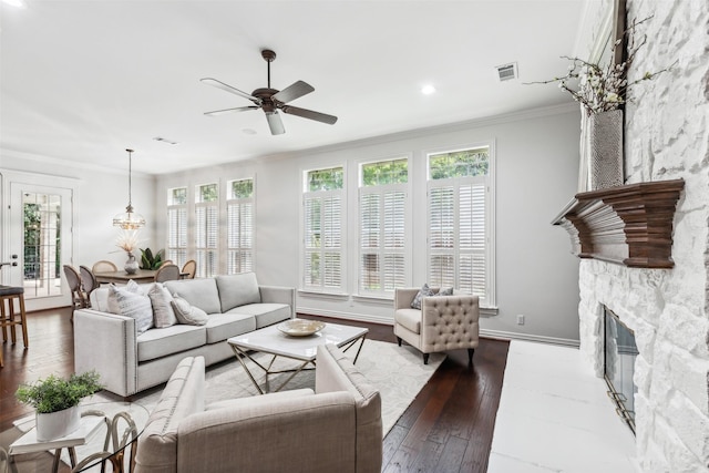 living room with ceiling fan, a fireplace, crown molding, and hardwood / wood-style flooring