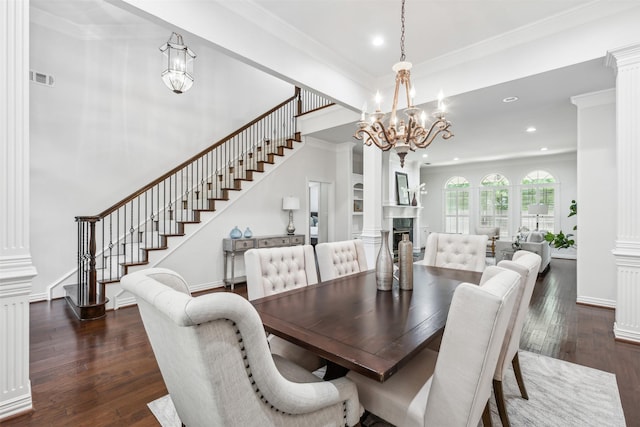 dining area with dark hardwood / wood-style floors, ornate columns, and crown molding