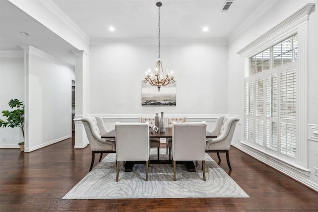 dining room with dark hardwood / wood-style flooring, ornamental molding, and an inviting chandelier