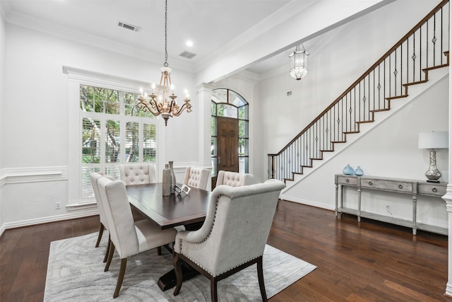 dining space featuring a notable chandelier, dark hardwood / wood-style flooring, and crown molding