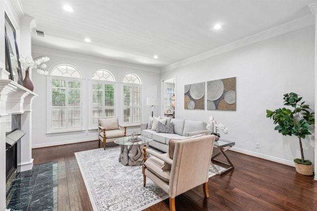 living room featuring dark hardwood / wood-style flooring, ornamental molding, and a tile fireplace